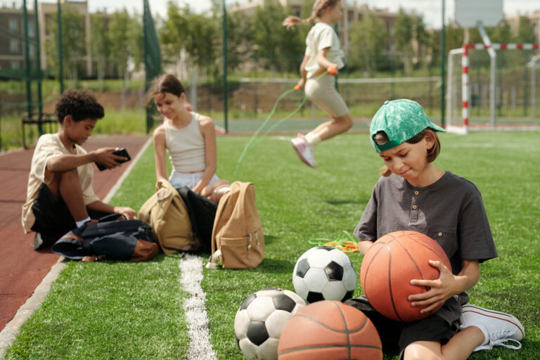cute-schoolboy-looking-at-basketball-ball-in-his-h-2025-03-14-00-01-11-utc-web